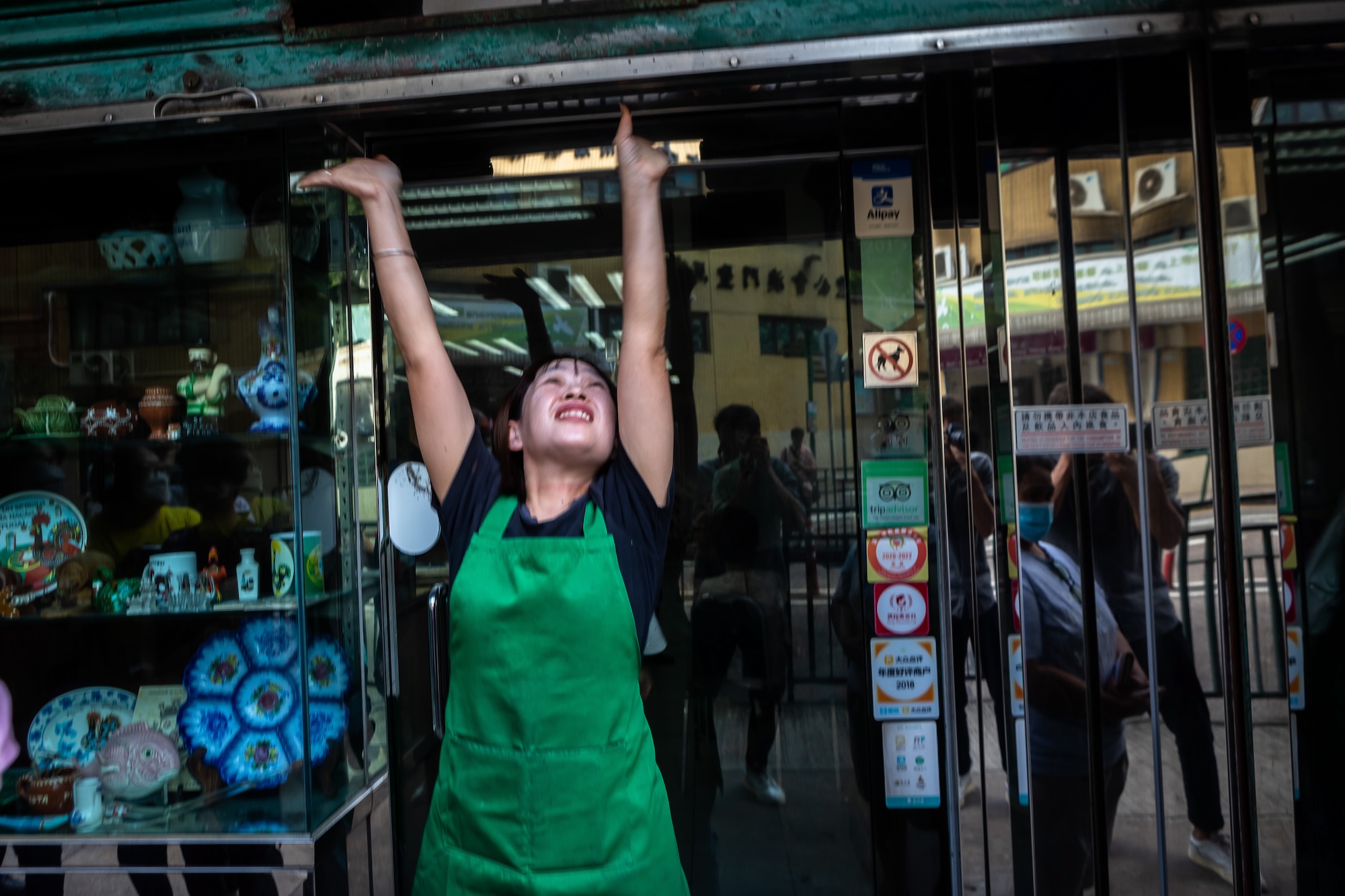 A staff member raises the shutters for the last time