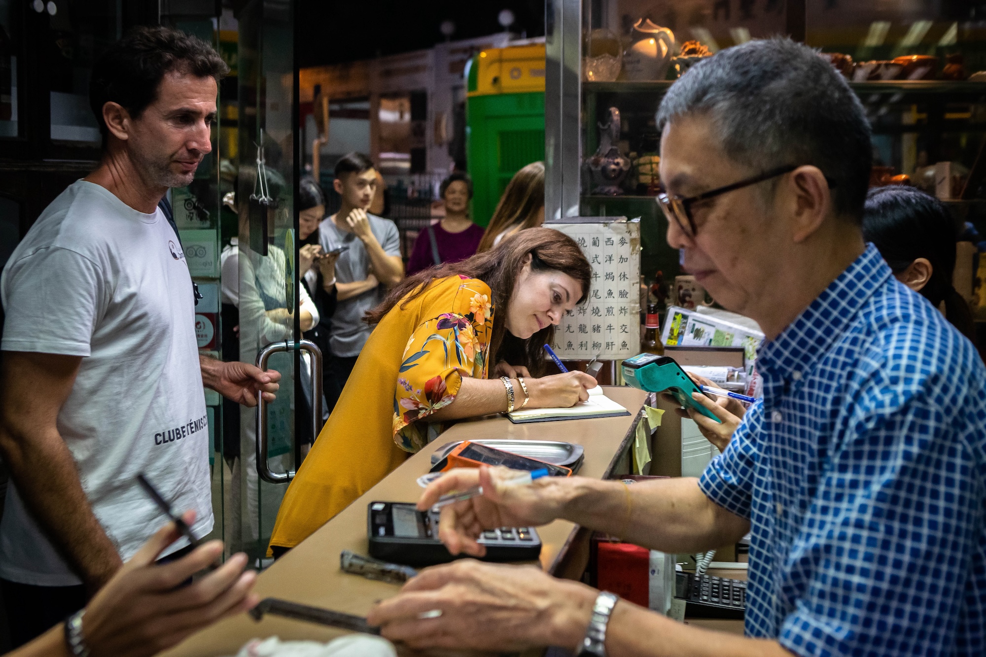 Customers write their farewell messages in the guest book